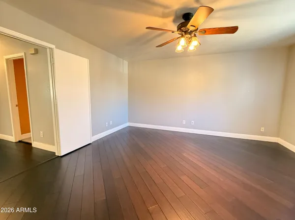 a view of a room with wooden floor