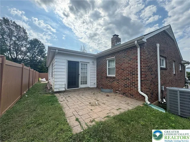 a backyard of a house with plants and trees