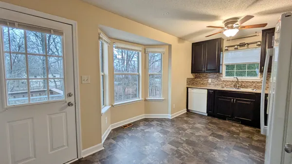 a spacious bathroom with a granite countertop sink and a large mirror