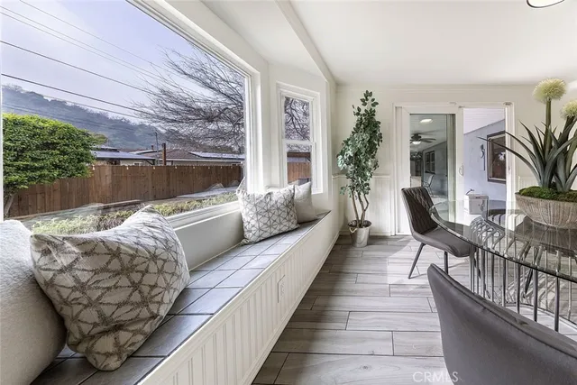 a living room with furniture a rug and a window