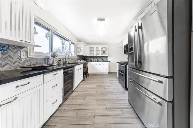 a kitchen with a sink a stove and cabinets