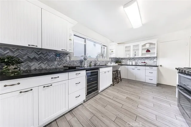 a large kitchen with stainless steel appliances granite countertop a stove and a sink