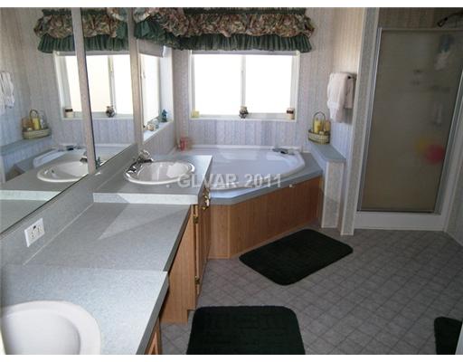 5560 Doubletree Road Pahrump, NV 89061 - Photo 11 of 25 Master Bath/Spa. Bright and cheery master bath features a corner garden tub and separate shower stall. Double sinks are separated by vanity.