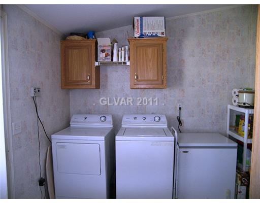 5560 Doubletree Road Pahrump, NV 89061 - Photo 16 of 25 Property Photo. Laundry room has space for an upright freezer plus storage. Washer and dryer will stay.
