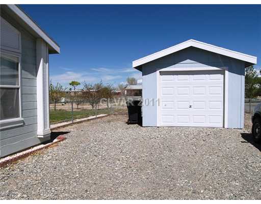 5560 Doubletree Road Pahrump, NV 89061 - Photo 18 of 25 Parking Lot. Gravel driveway leads to garage.