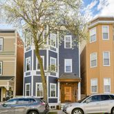 a couple of cars parked in front of a building