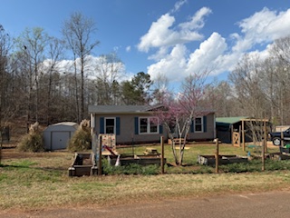 310 Nebo Church Road Seneca, SC 29678 - Photo 27 of 27 This charming home offers comfortable living with a spacious yard and wooded backdrop.
