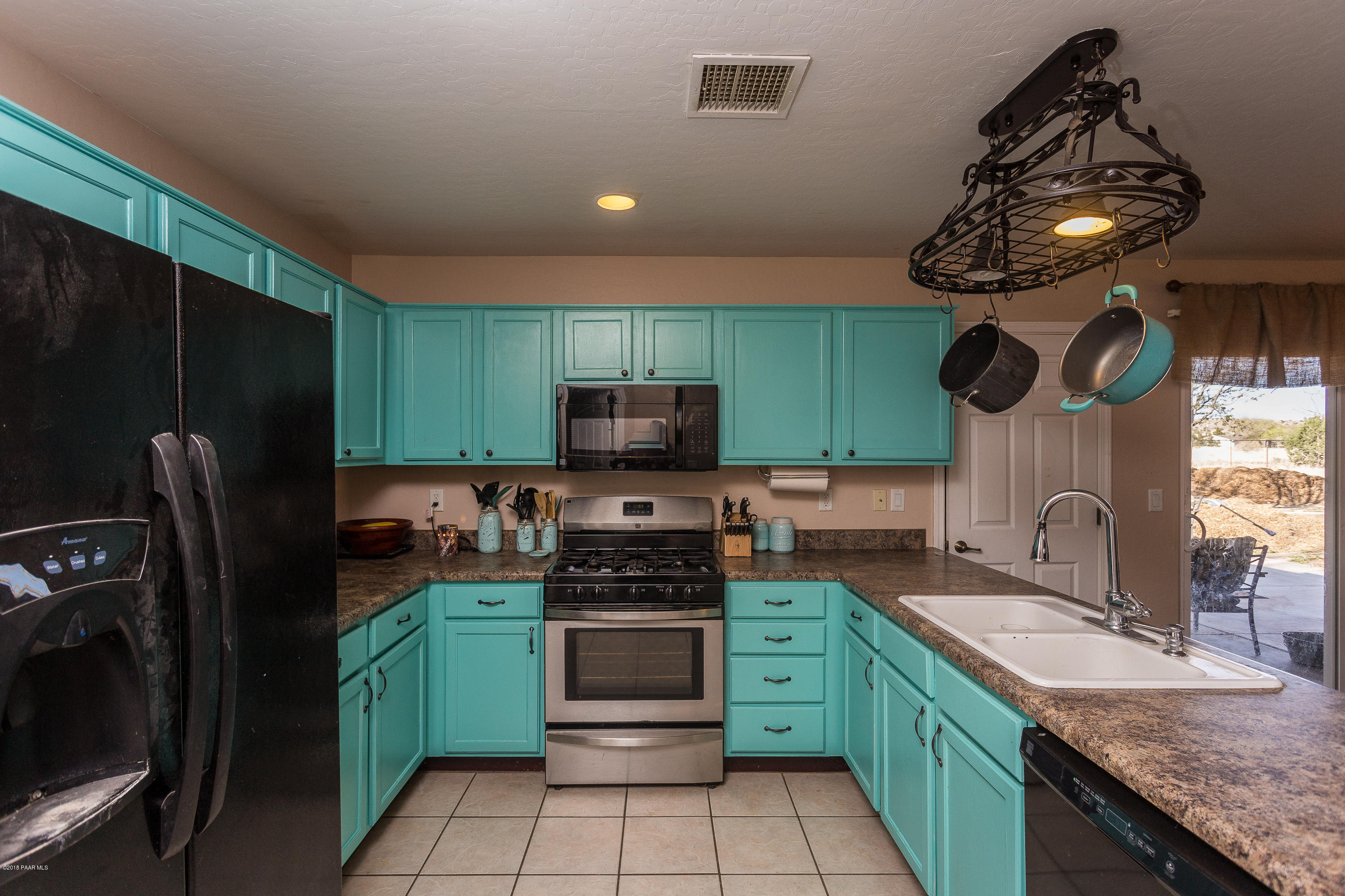 25805 Poppy Road Paulden, AZ 86334 - Photo 8 of 17 a kitchen with kitchen island granite countertop stainless steel appliances and a sink