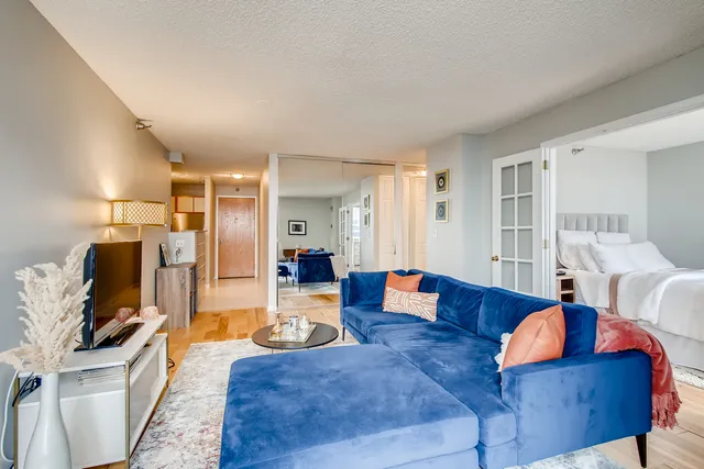 a living room with furniture and wooden floor