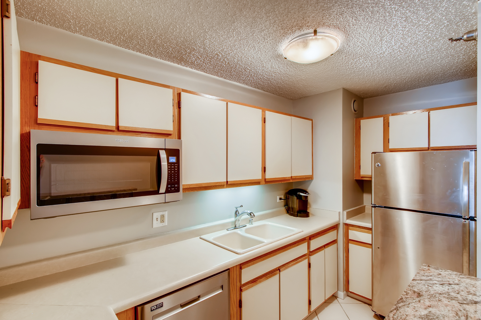 1122 North Clark Street, Unit 3205 Chicago, IL 60610 - Photo 9 of 16 a kitchen with stainless steel appliances a microwave sink and cabinets