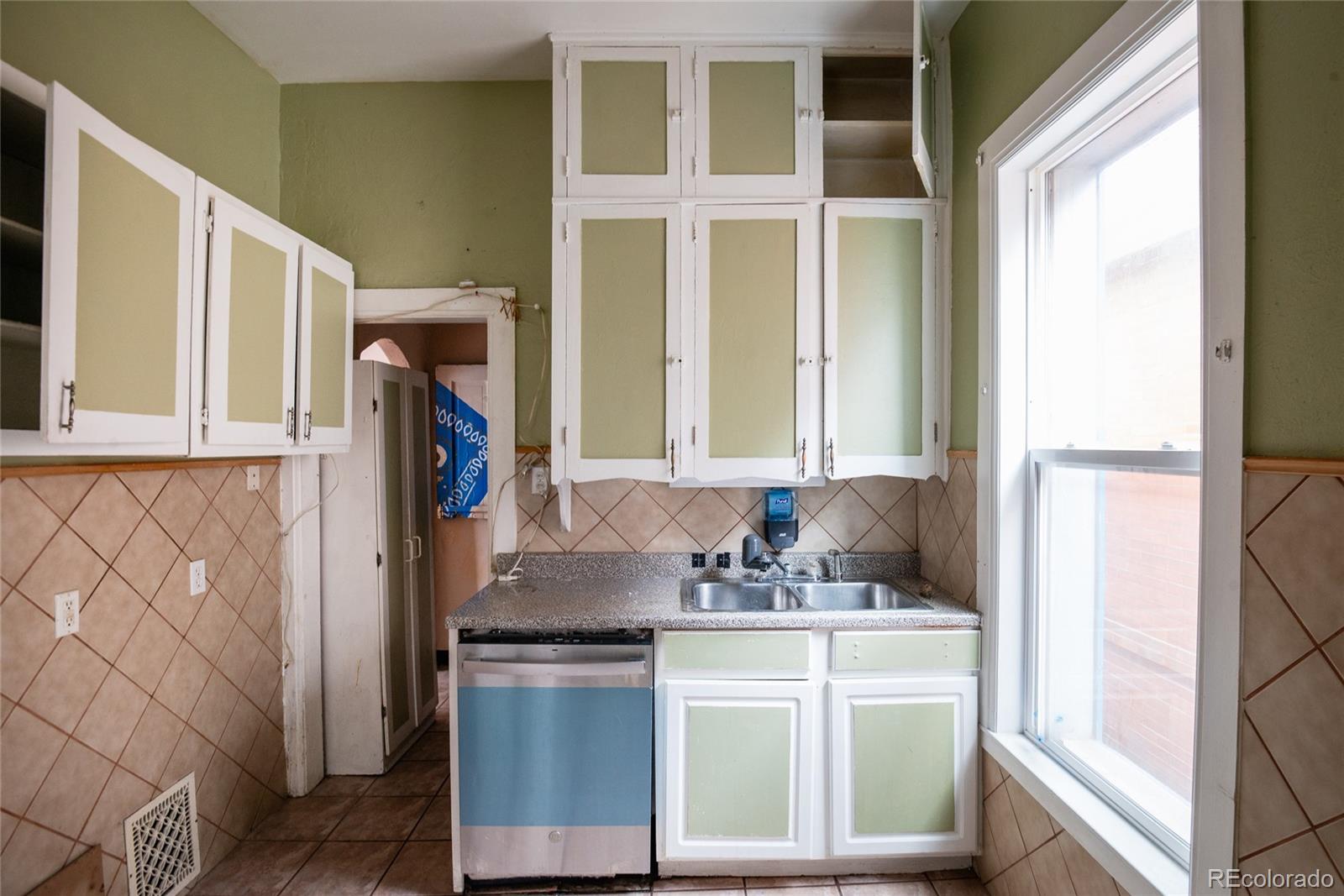 662 South Logan Street Denver, CO 80209 - Photo 6 of 25 a bathroom with a granite countertop sink and a mirror