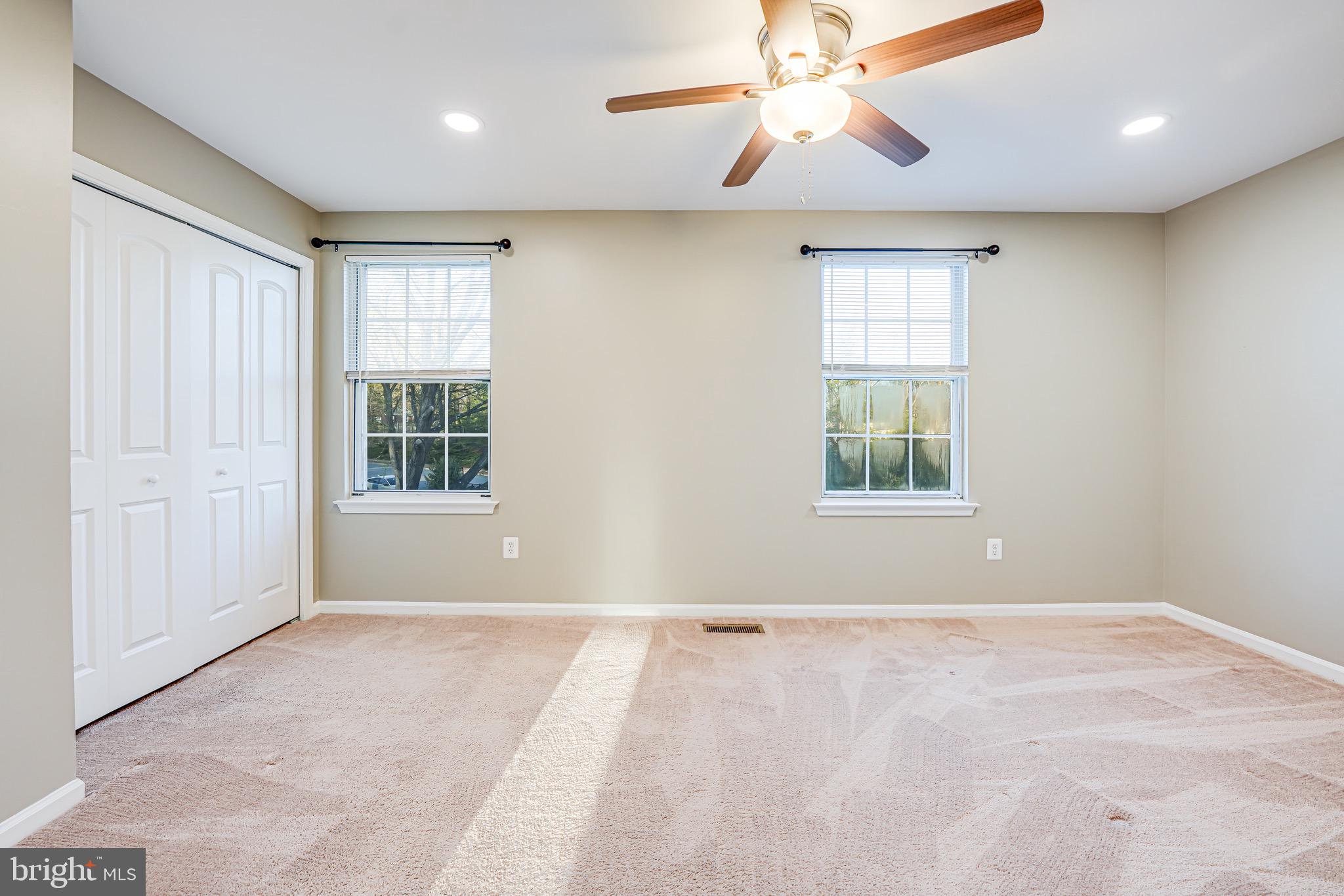 15592 Northgate Drive Dumfries, VA 22025 - Photo 12 of 51 en empty room with windows and chandelier fan