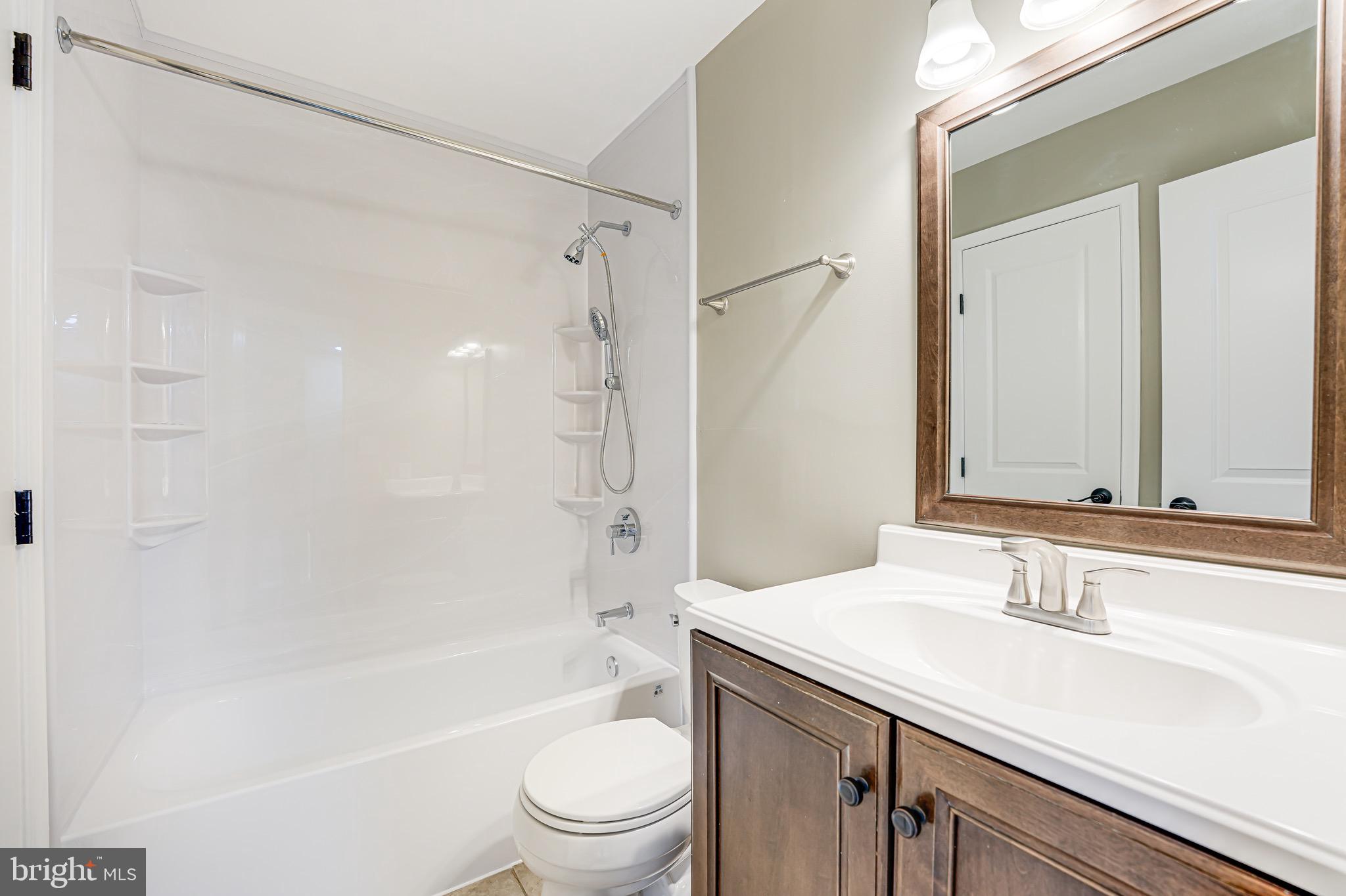 15592 Northgate Drive Dumfries, VA 22025 - Photo 13 of 51 a bathroom with a granite countertop sink toilet and shower