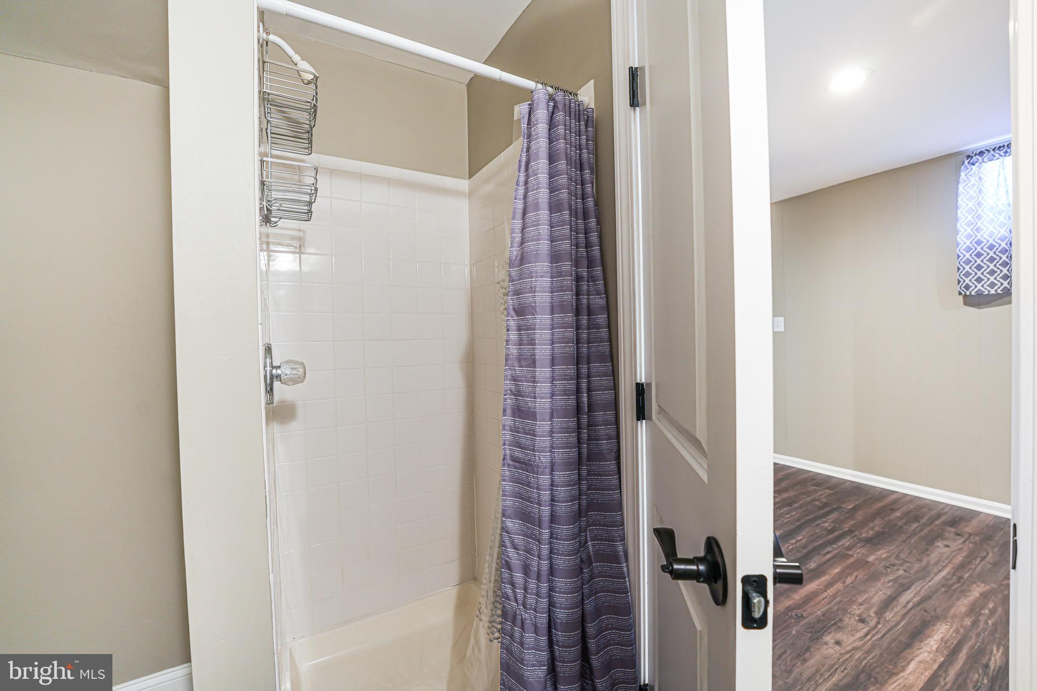 15592 Northgate Drive Dumfries, VA 22025 - Photo 17 of 51 a view of a bathroom with a shower and a glass door