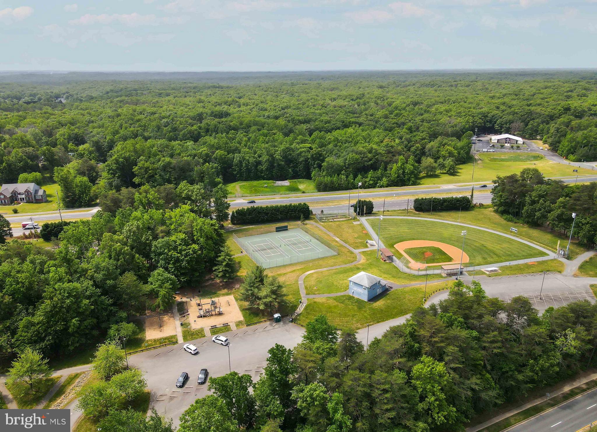 15592 Northgate Drive Dumfries, VA 22025 - Photo 49 of 51 an aerial view of a house with a swimming pool yard and mountain view in back