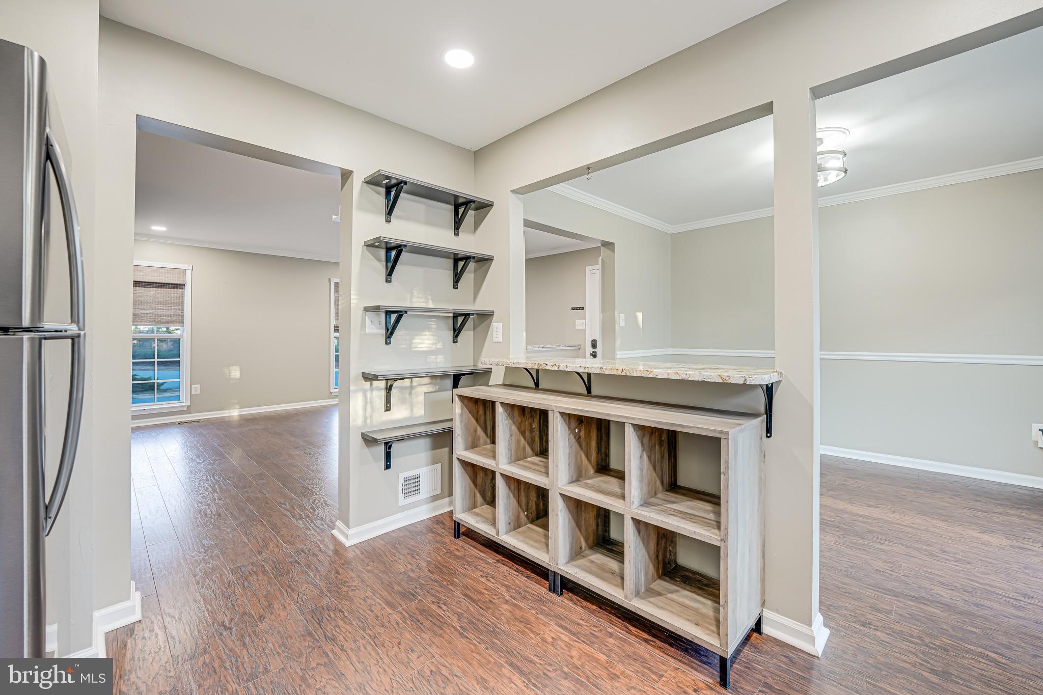 15592 Northgate Drive Dumfries, VA 22025 - Photo 5 of 51 a view of a large room with wooden floor and windows