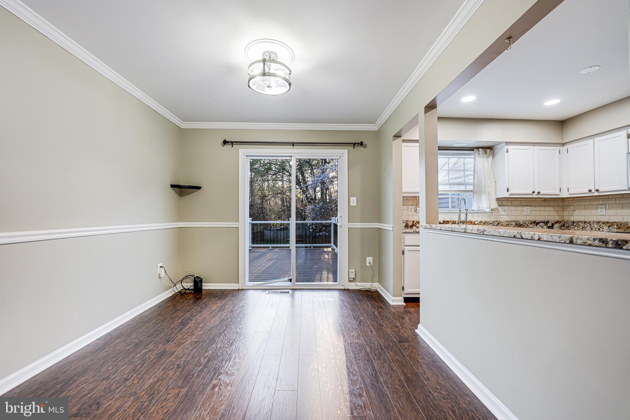 15592 Northgate Drive Dumfries, VA 22025 - Photo 6 of 51 a view of a kitchen with a fridge and wooden floor