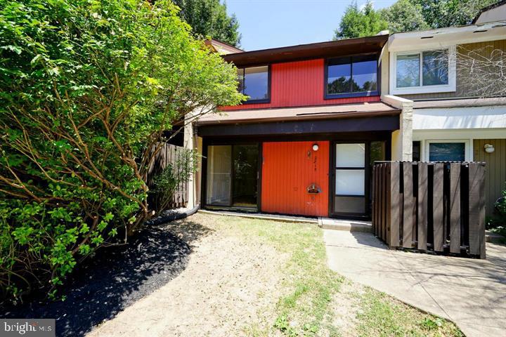 2215 Coppersmith Square Reston, VA 20191 - Photo 1 of 13 a front view of a house with a yard and garage