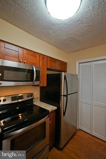 2215 Coppersmith Square Reston, VA 20191 - Photo 11 of 13 a kitchen with stainless steel appliances a refrigerator and a microwave