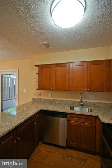 2215 Coppersmith Square Reston, VA 20191 - Photo 12 of 13 a kitchen with a sink a stove and cabinets