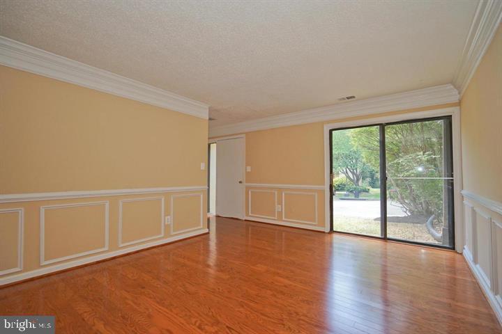 2215 Coppersmith Square Reston, VA 20191 - Photo 5 of 13 a view of an empty room with wooden floor and a window