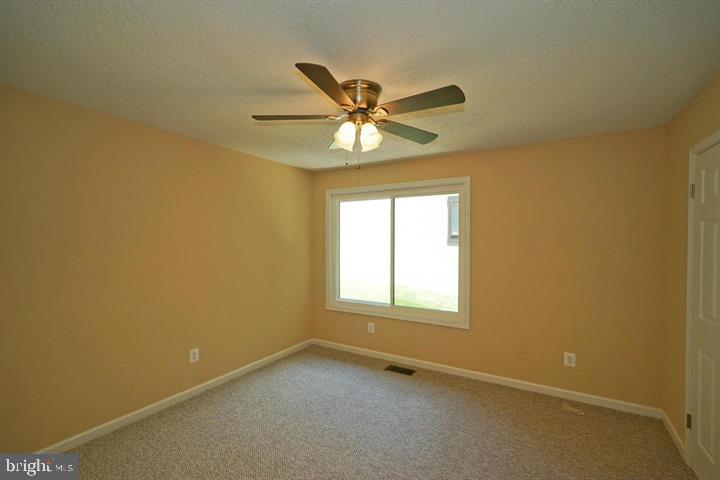 2215 Coppersmith Square Reston, VA 20191 - Photo 10 of 13 an empty room with a window and a fan