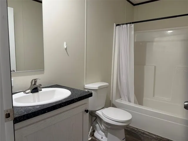 a bathroom with a sink toilet and a mirror