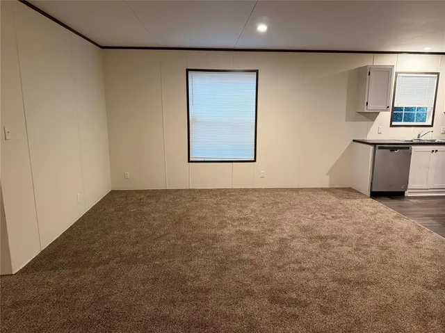 a room with a wooden floor and a window