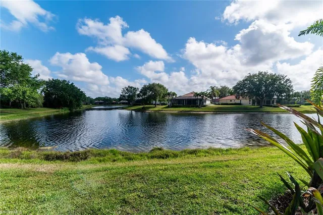 a view of a lake with houses in the back