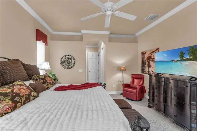 a bedroom with a bed a chandelier and closet