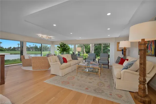 a living room with furniture and a floor to ceiling window