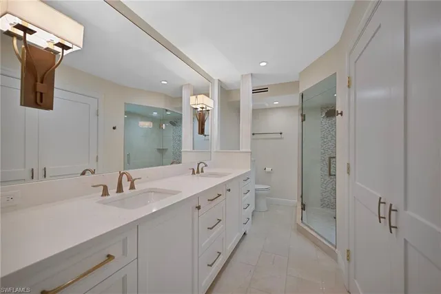 a spacious bathroom with a double vanity sink mirror double and shower