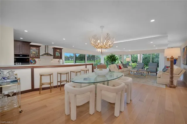 a large kitchen with a table and chairs