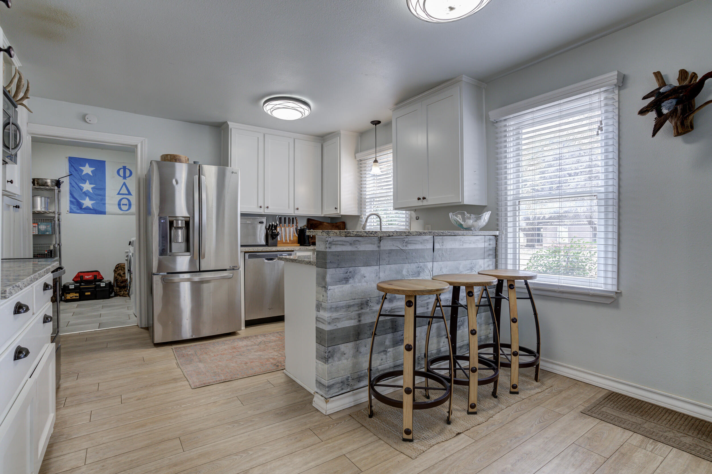 2515 33rd Street Lubbock, TX 79410 - Photo 15 of 41 a kitchen with refrigerator a table and chairs