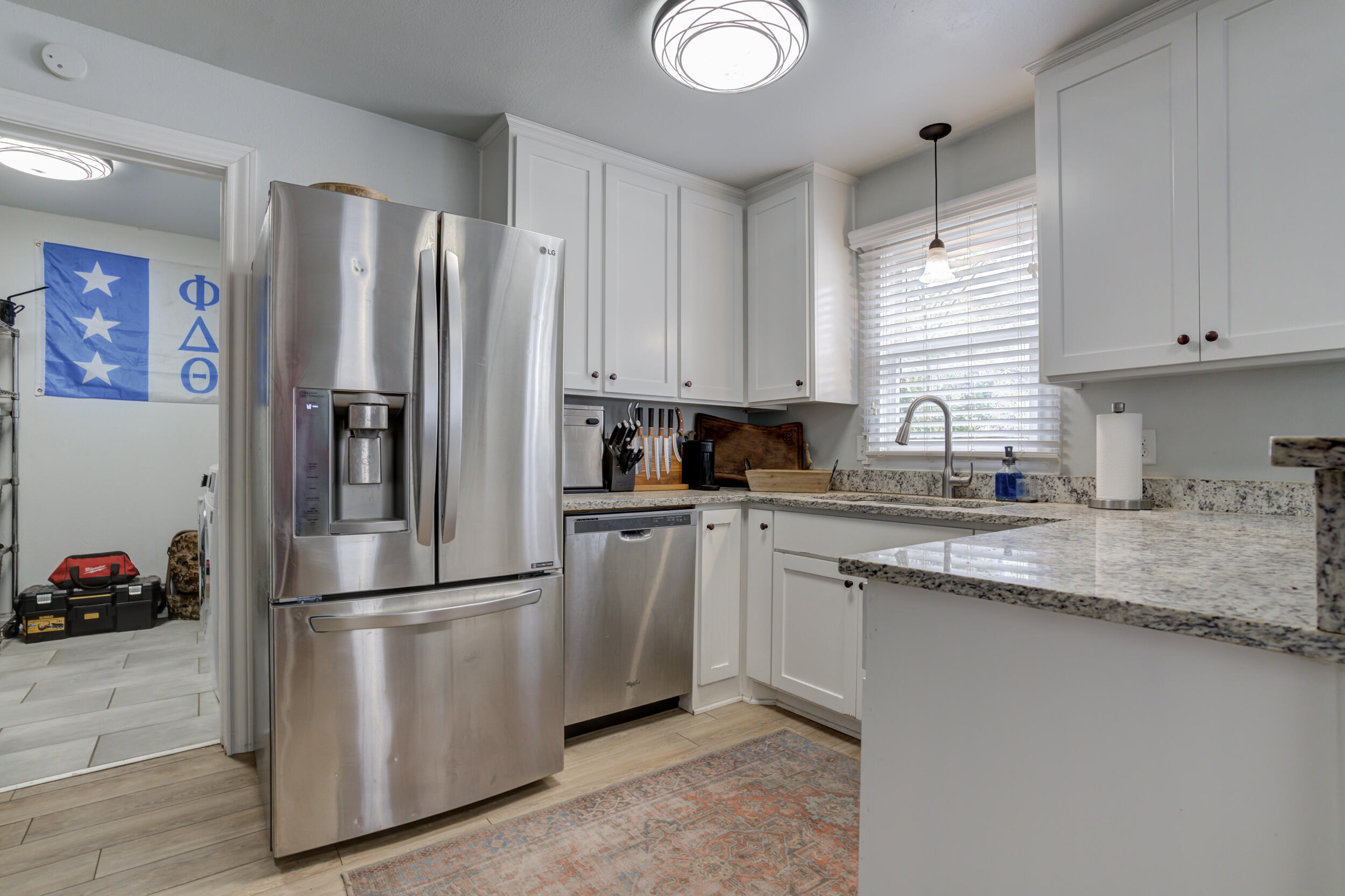 2515 33rd Street Lubbock, TX 79410 - Photo 17 of 41 a kitchen with stainless steel appliances granite countertop a refrigerator sink and white cabinets
