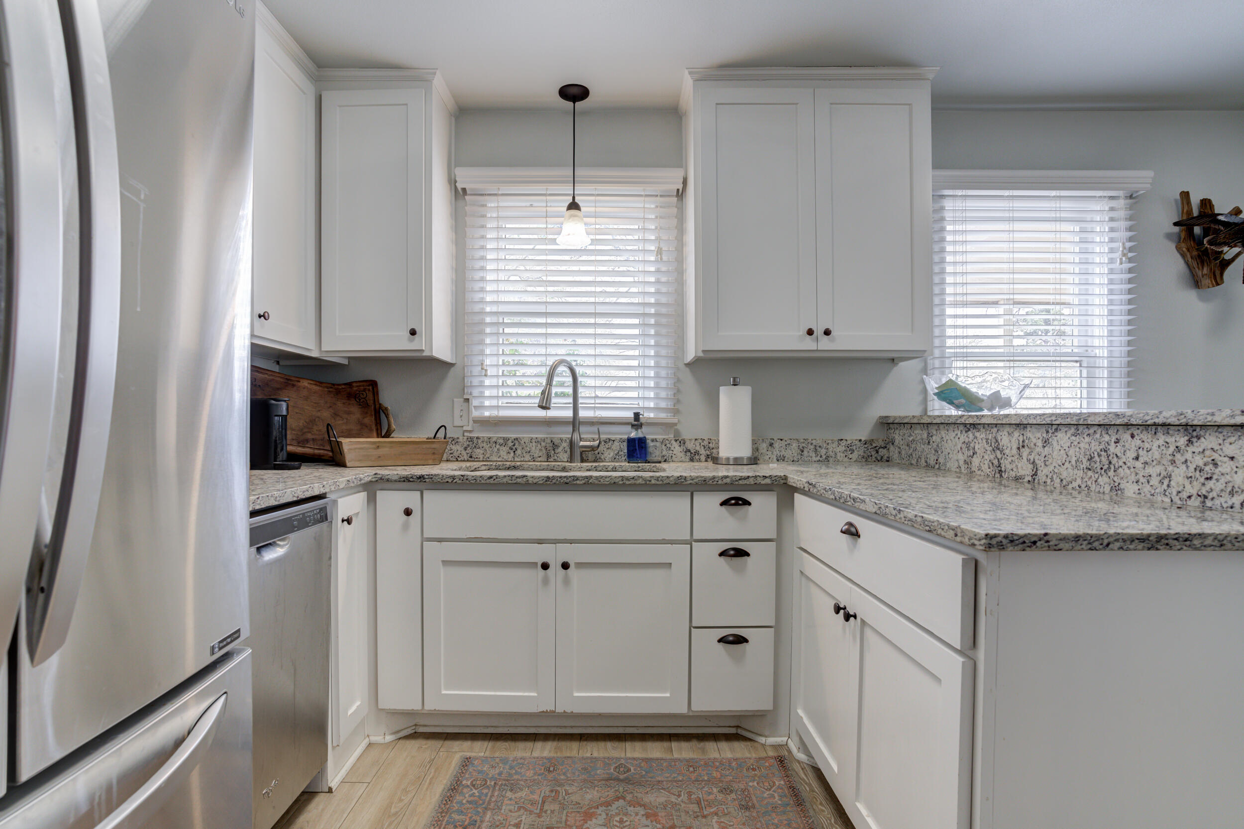 2515 33rd Street Lubbock, TX 79410 - Photo 18 of 41 a kitchen with granite countertop white cabinets sink and window