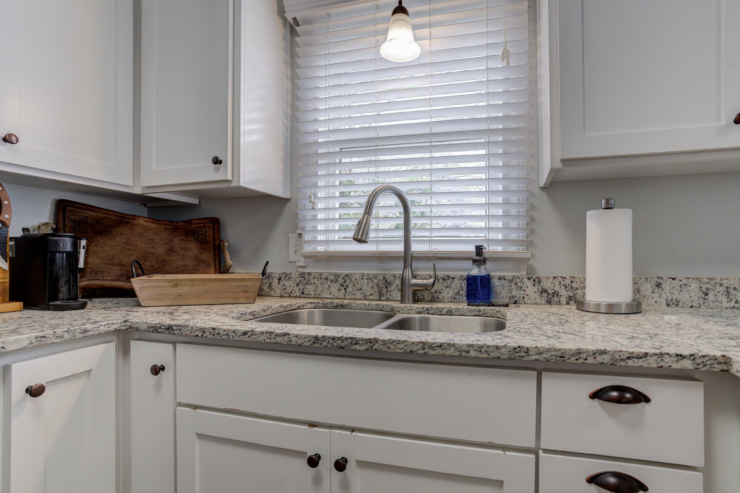 2515 33rd Street Lubbock, TX 79410 - Photo 19 of 41 a kitchen with granite countertop stainless steel appliances a sink and cabinets