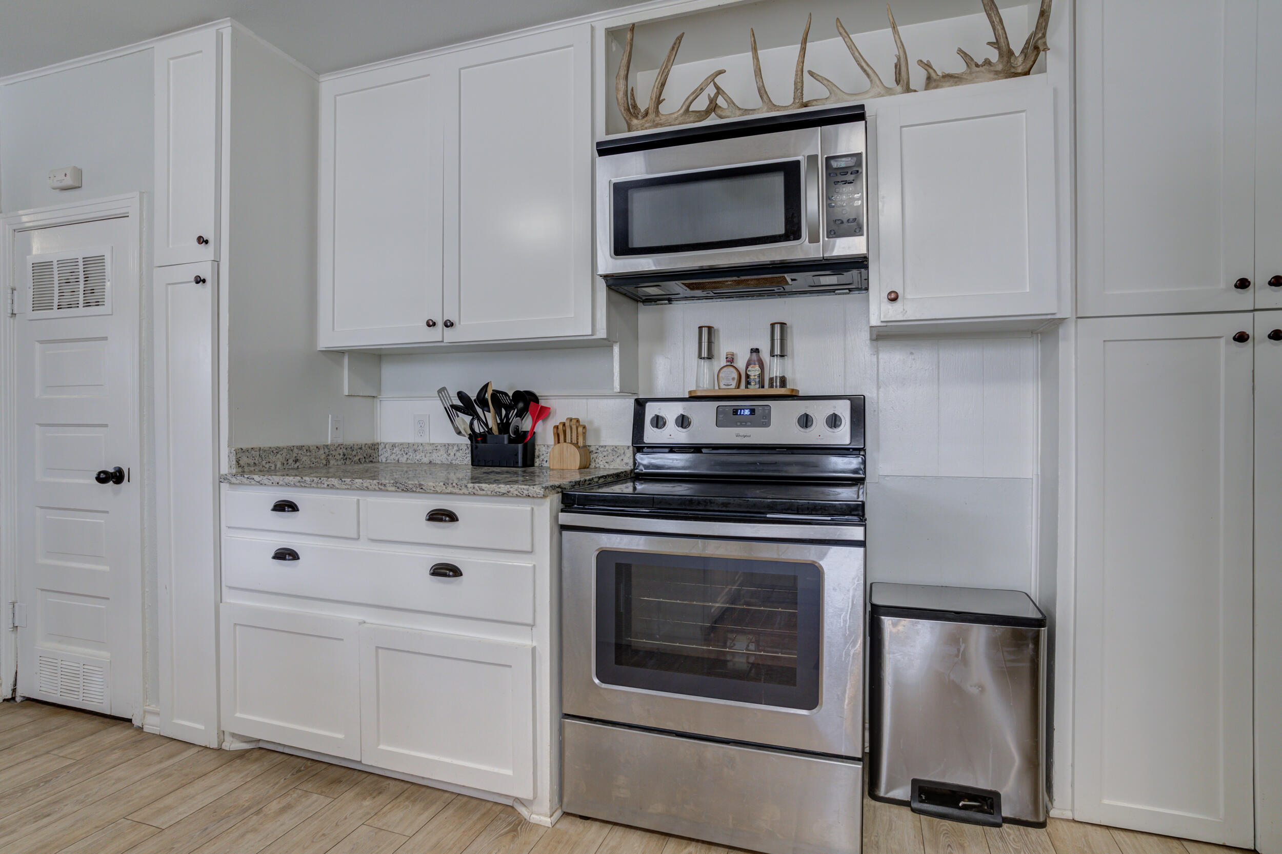 2515 33rd Street Lubbock, TX 79410 - Photo 20 of 41 a kitchen with cabinets stainless steel appliances and wooden floor