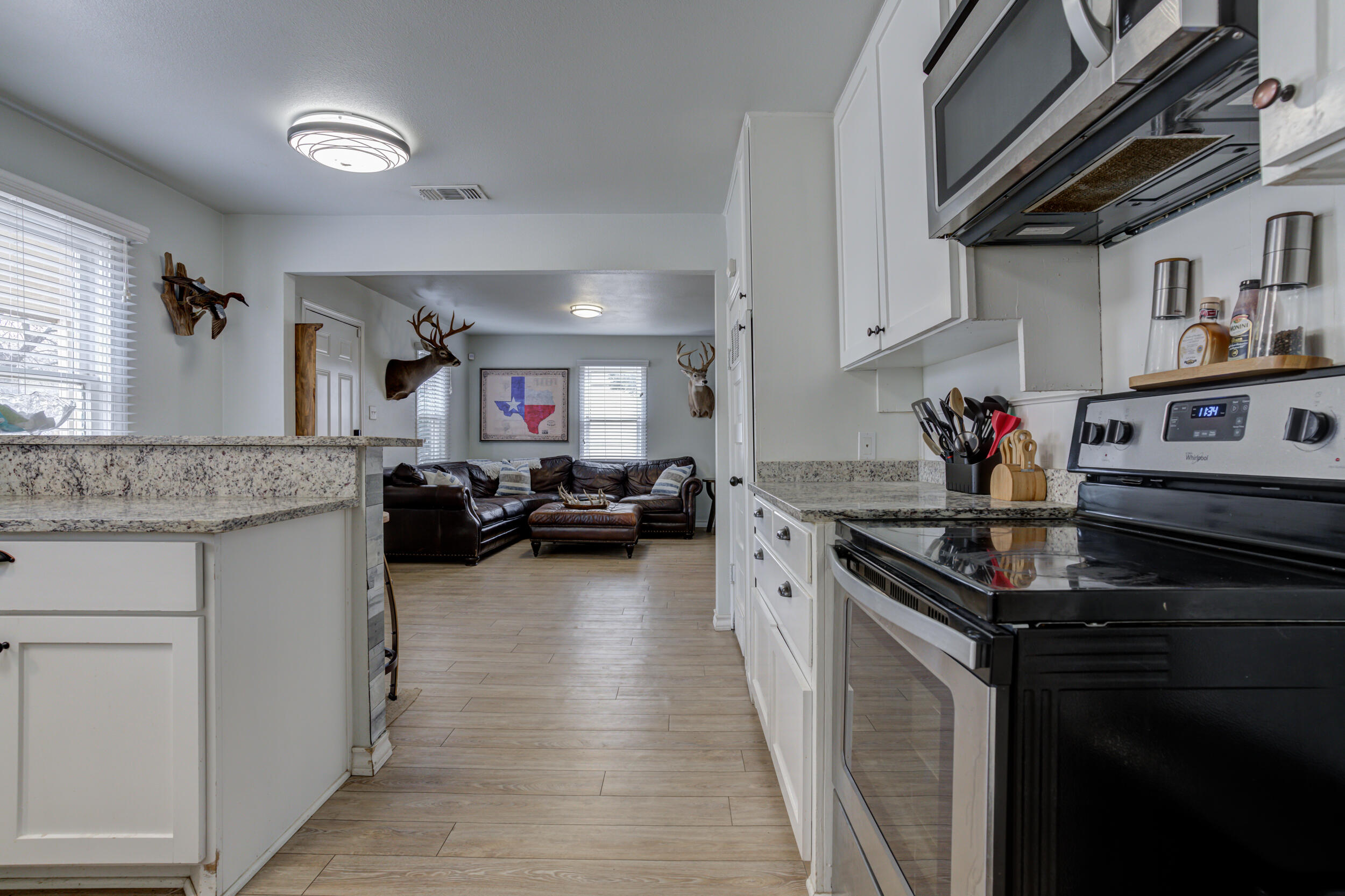2515 33rd Street Lubbock, TX 79410 - Photo 22 of 41 a kitchen with stainless steel appliances granite countertop a sink stove and cabinets