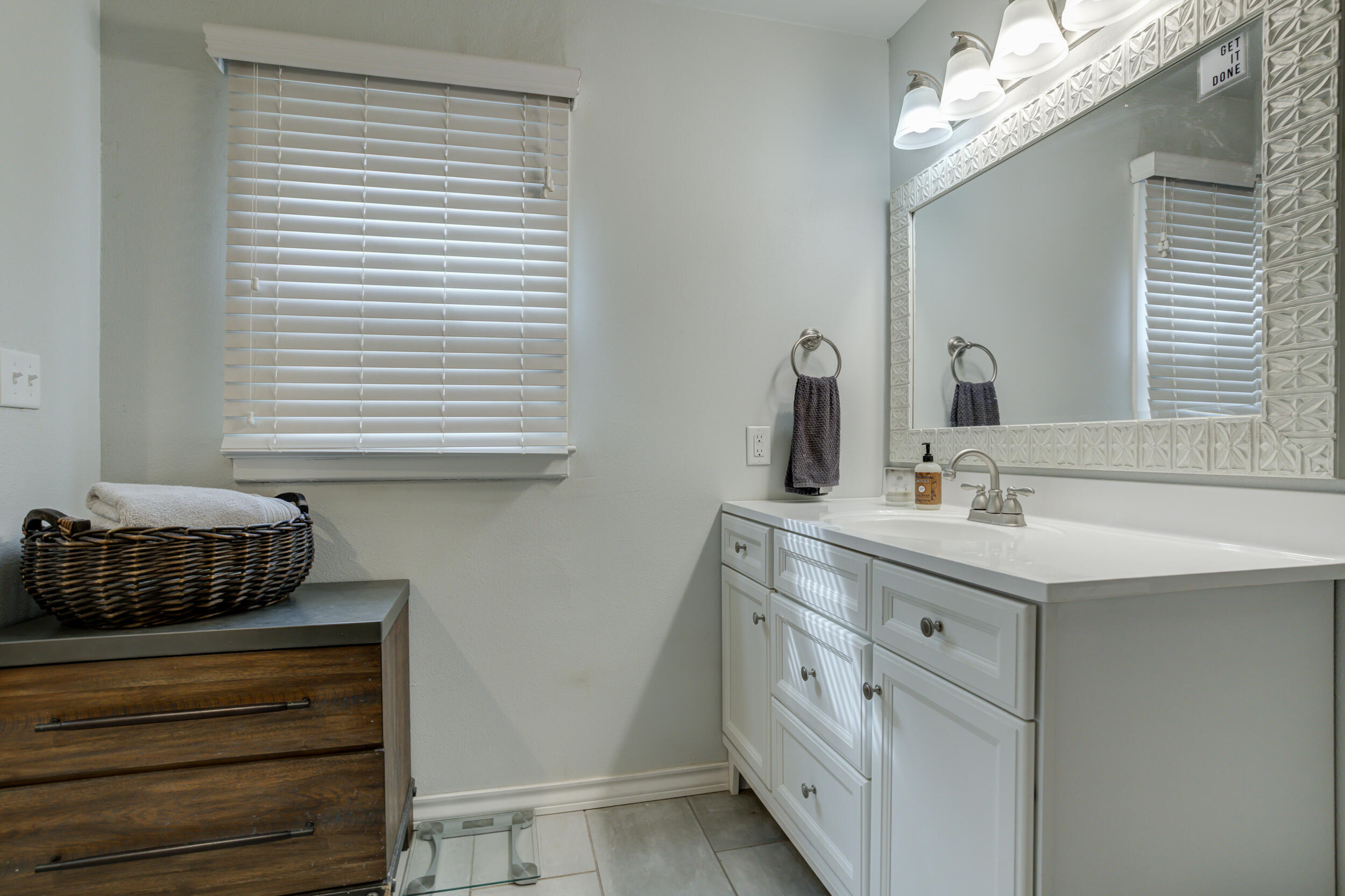2515 33rd Street Lubbock, TX 79410 - Photo 28 of 41 a bathroom with a sink and a mirror