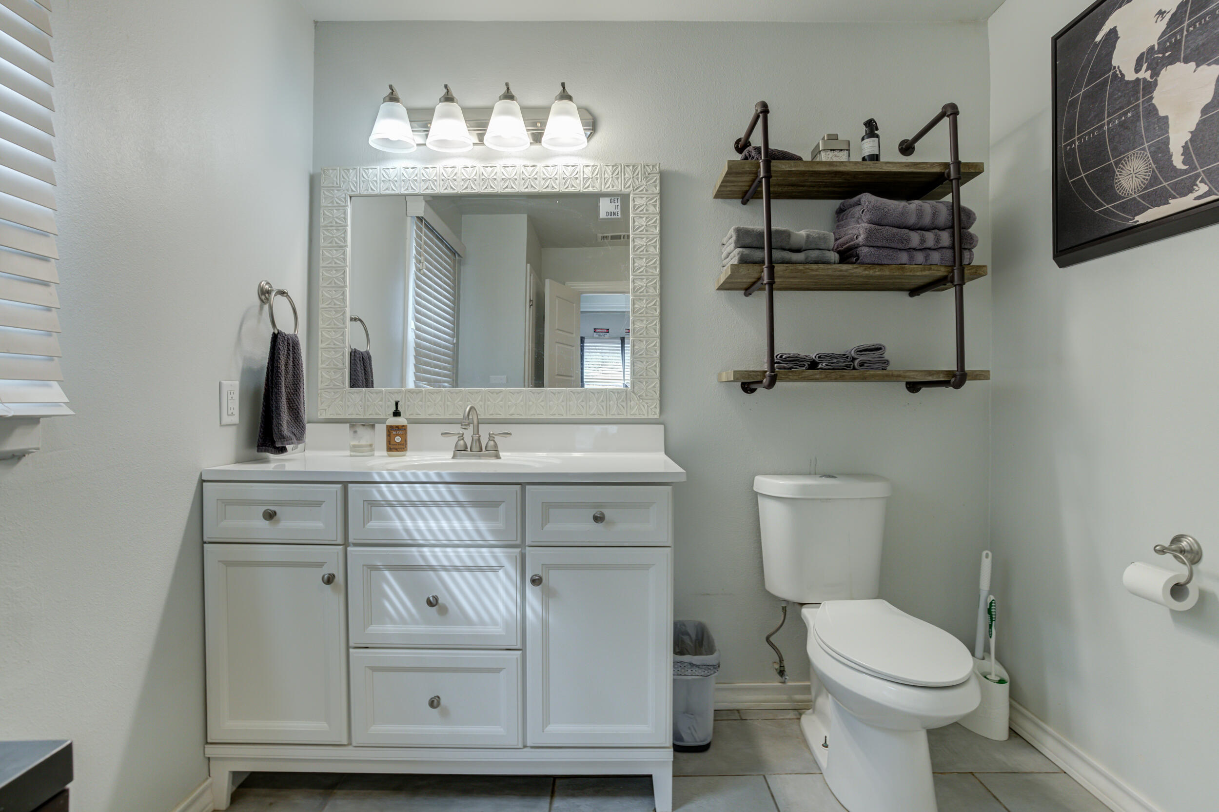 2515 33rd Street Lubbock, TX 79410 - Photo 29 of 41 a bathroom with a toilet sink and mirror