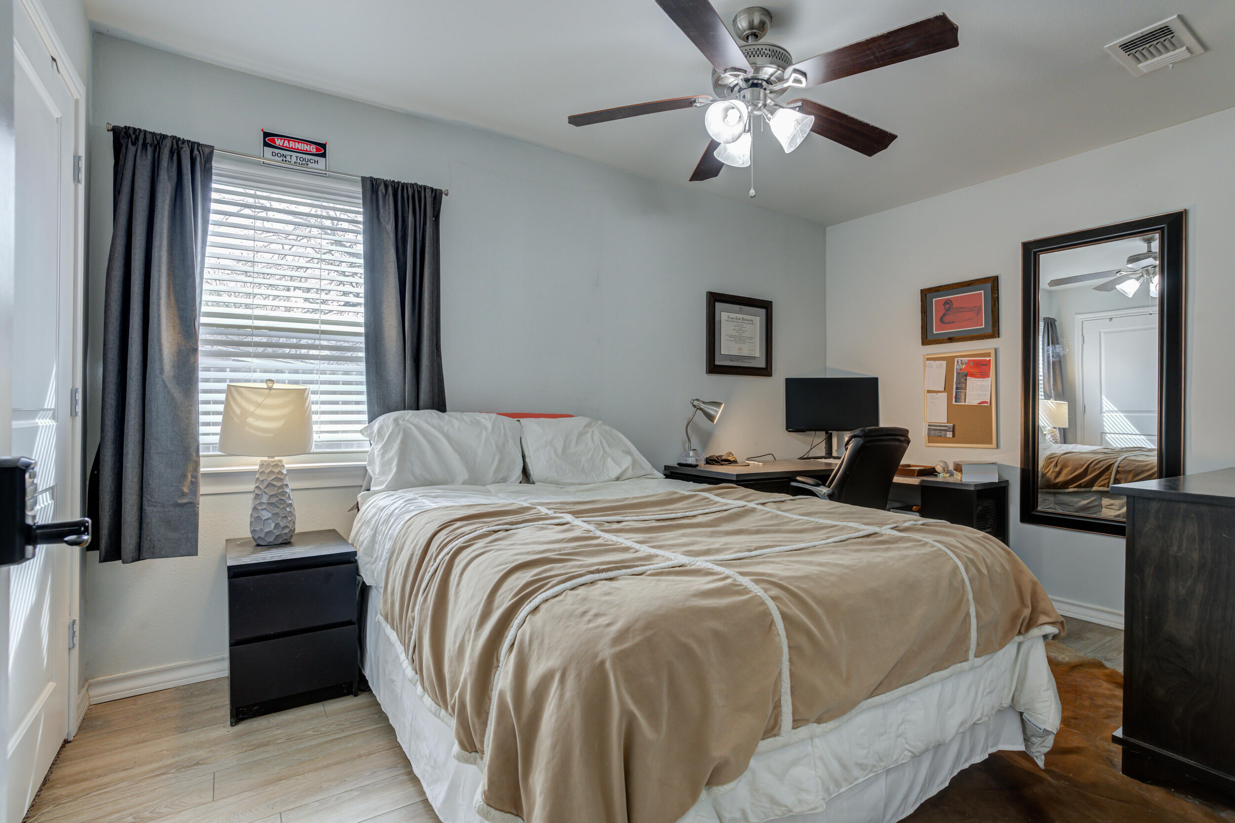 2515 33rd Street Lubbock, TX 79410 - Photo 33 of 41 a bed room with a bed and a chandelier