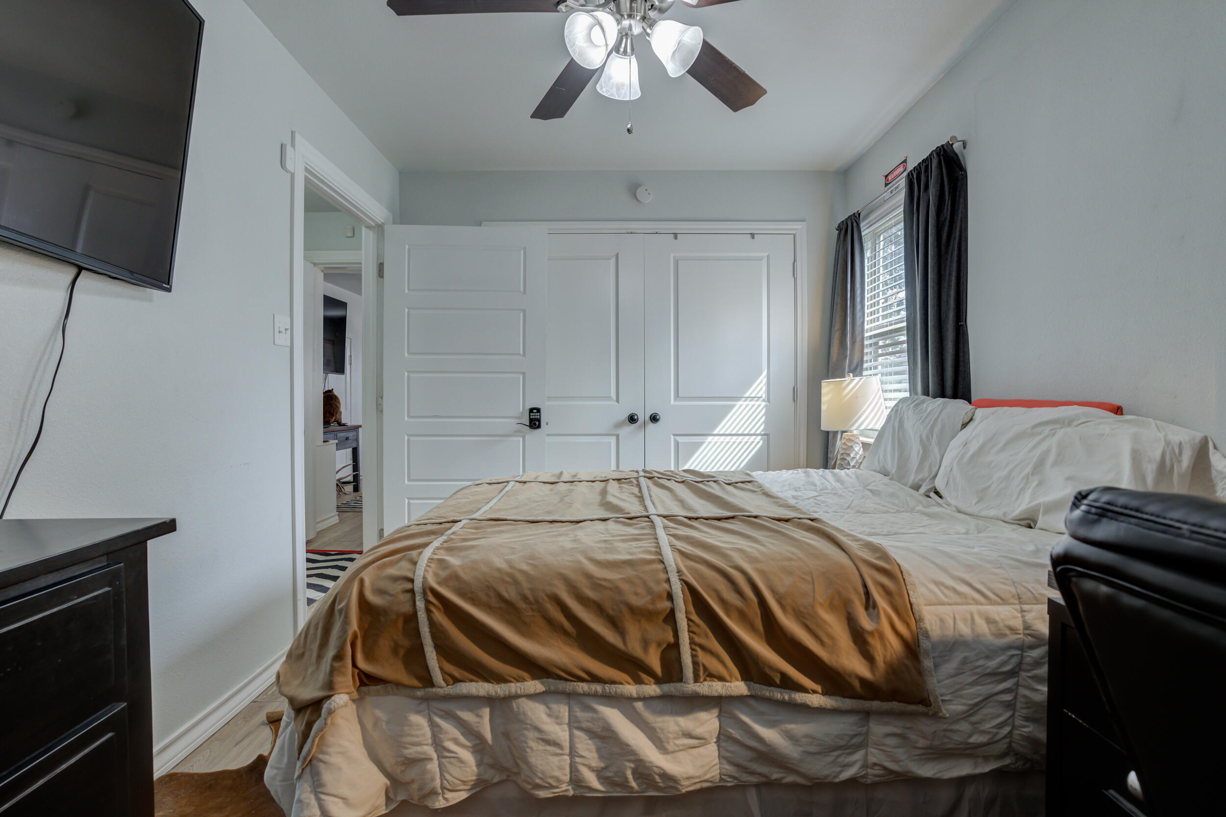 2515 33rd Street Lubbock, TX 79410 - Photo 34 of 41 a bedroom with a bed and a chandelier