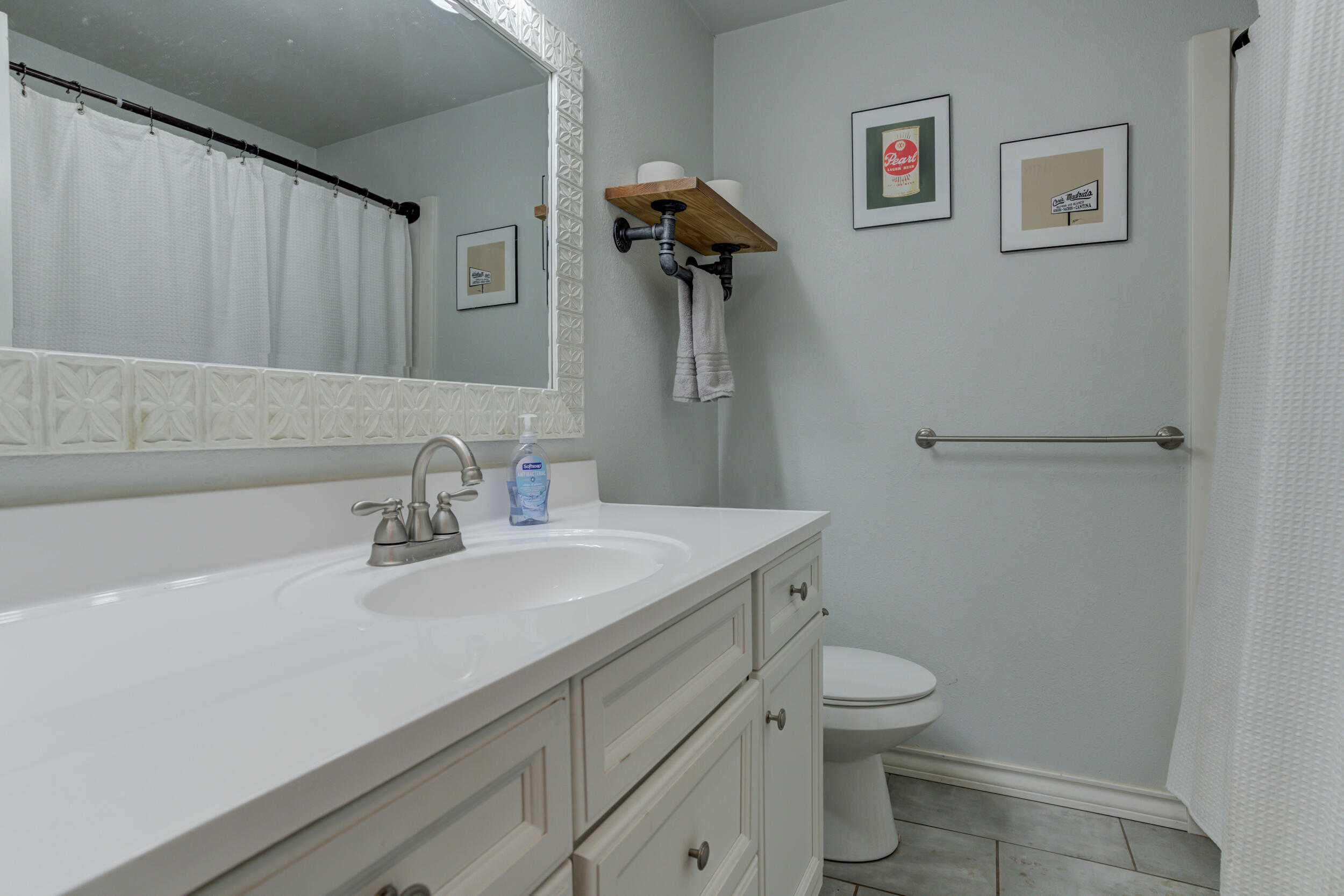2515 33rd Street Lubbock, TX 79410 - Photo 35 of 41 a bathroom with a granite countertop sink a toilet and a mirror