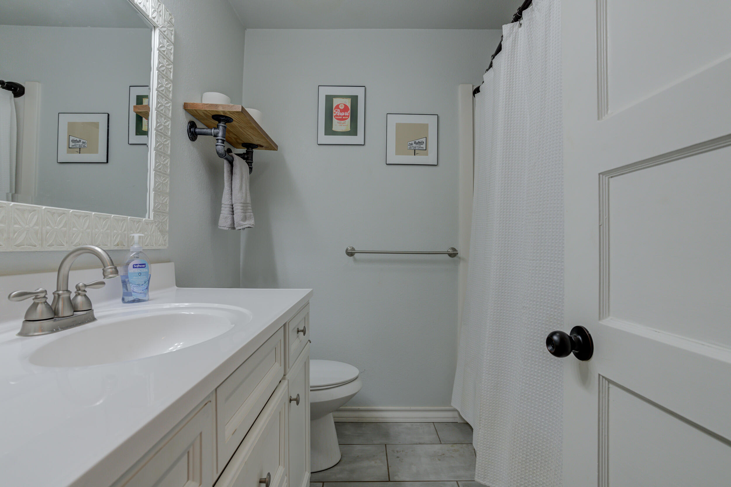 2515 33rd Street Lubbock, TX 79410 - Photo 36 of 41 a bathroom with a toilet sink and mirror