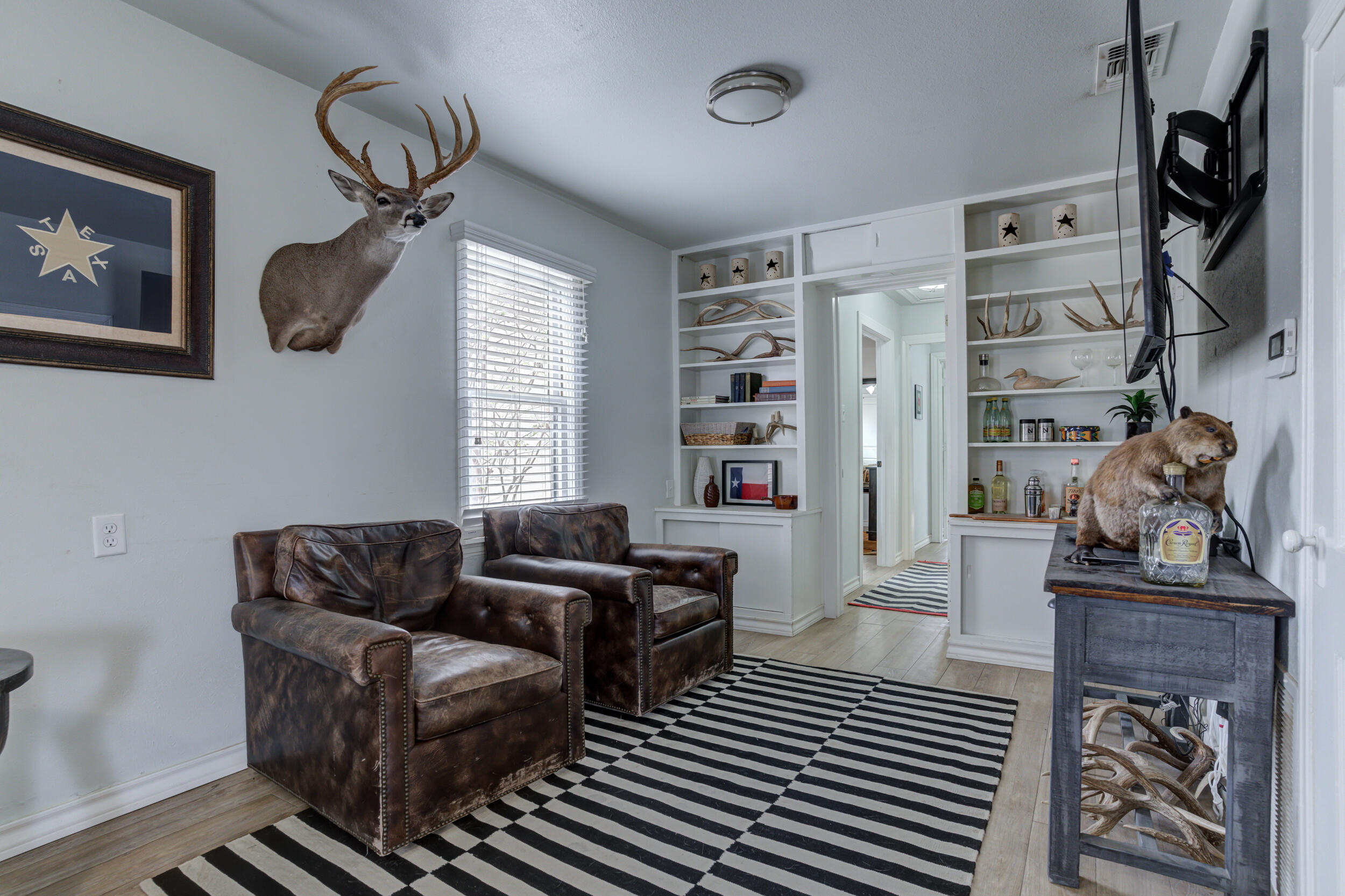 2515 33rd Street Lubbock, TX 79410 - Photo 10 of 41 a living room with furniture a rug and wall paintings