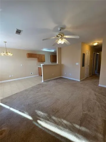 en empty room with windows and fan