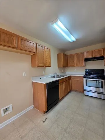 a kitchen with stainless steel appliances kitchen island granite countertop a stove and cabinets