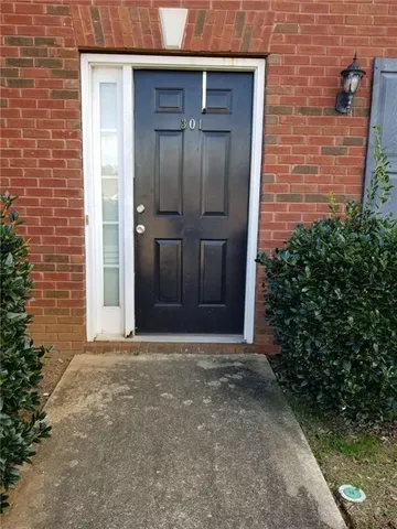 a view of a wooden door and a tree