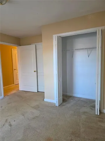 a view of an empty room with a closet